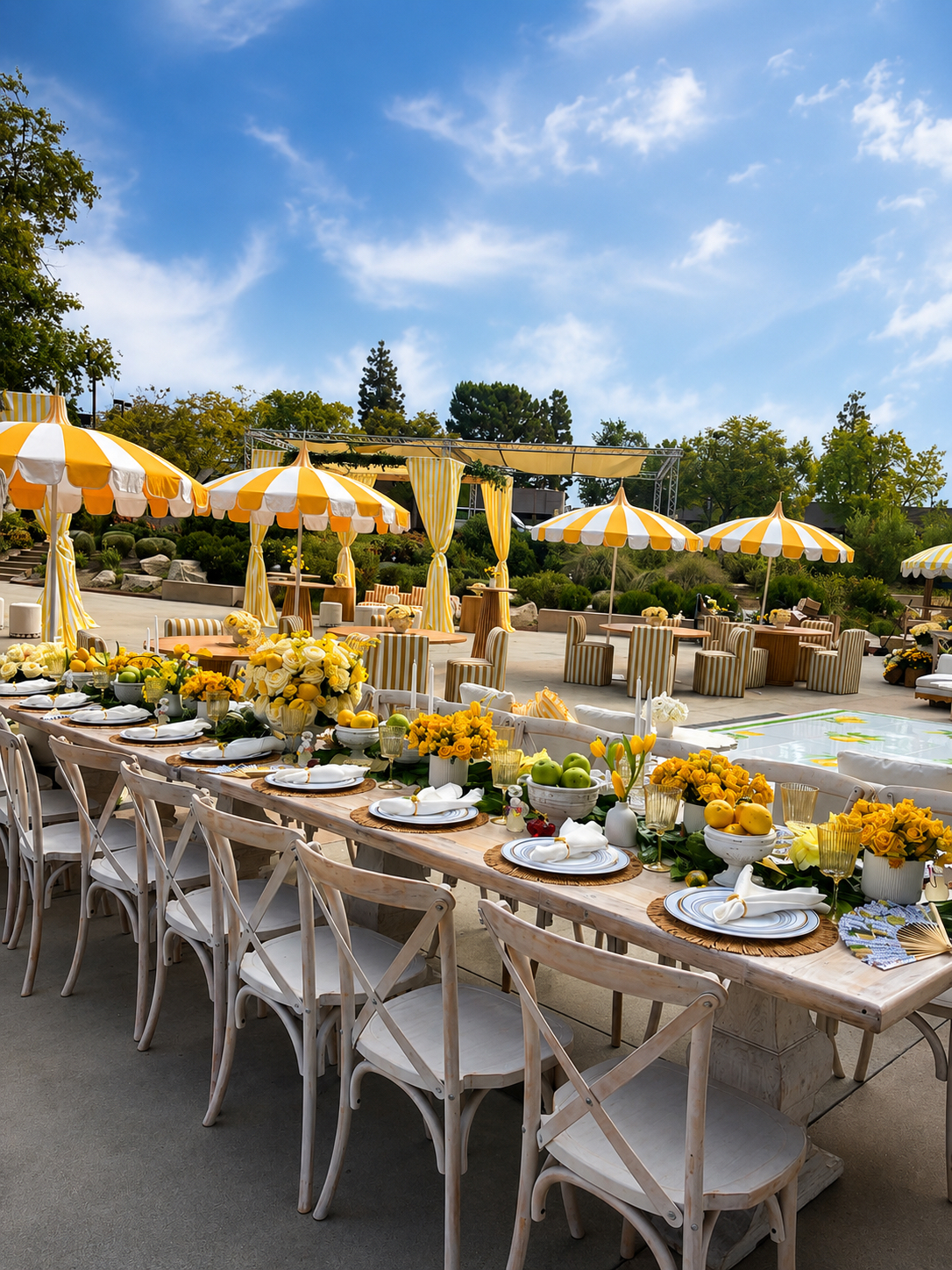 Yellow-and-white citrus garden party with roses, lemons, and striped umbrellas