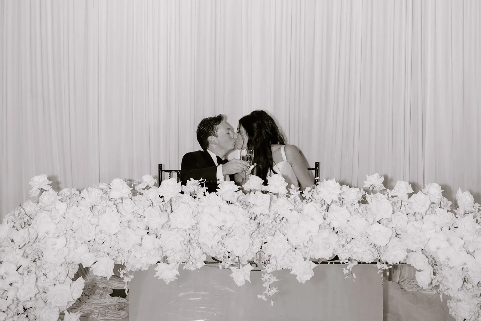 Gianna and Austin sharing a toast at their sweetheart table