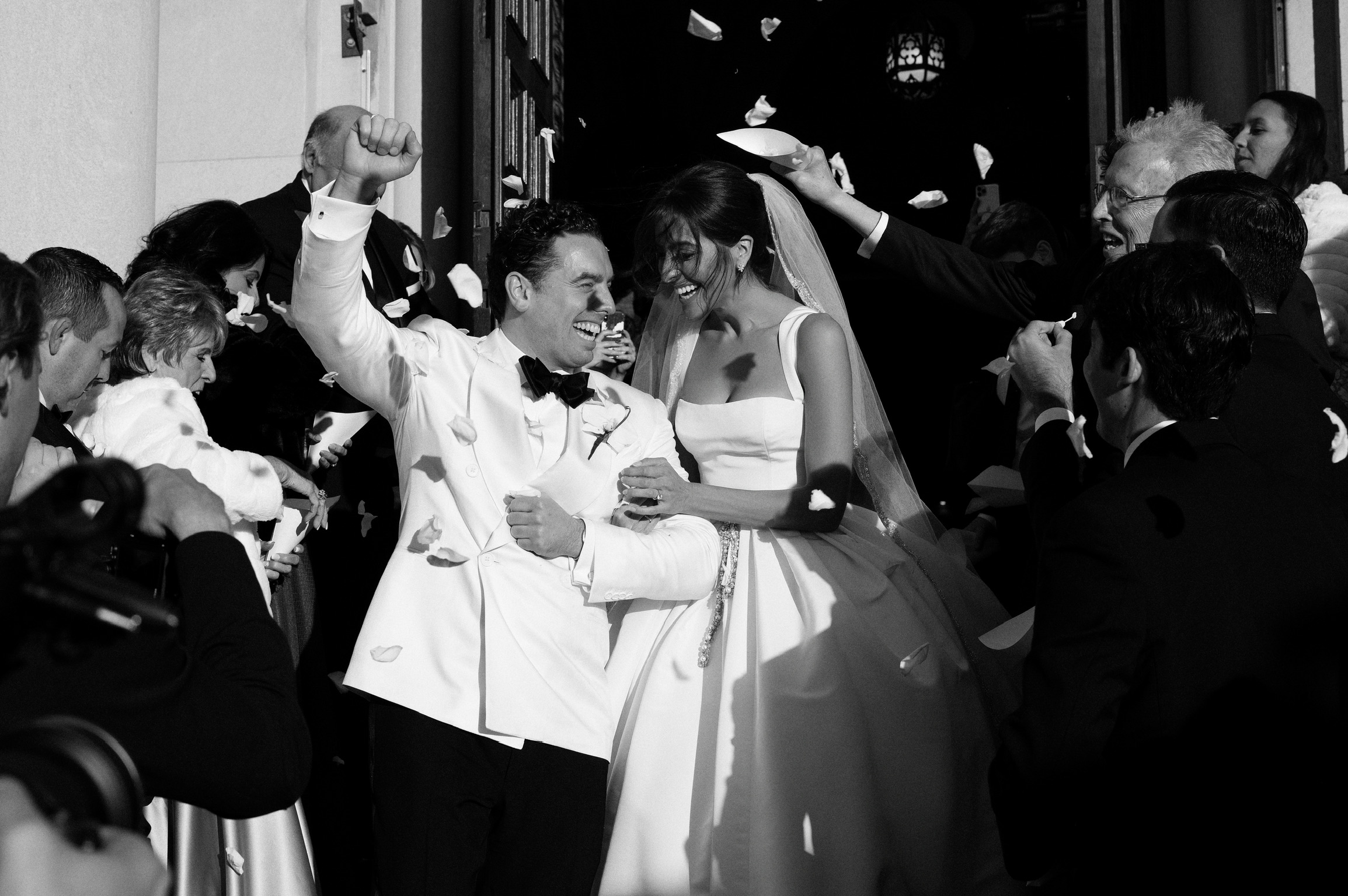 Newlyweds leaving their ceremony under falling petals, planned by Michigan Avenue Events