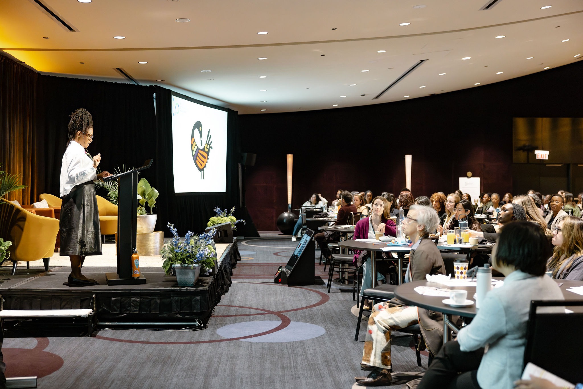 Keynote speaker at the podium addressing seated attendees in a round ballroom at the 2026 Irving Harris Foundation Planning and Development Network Conference