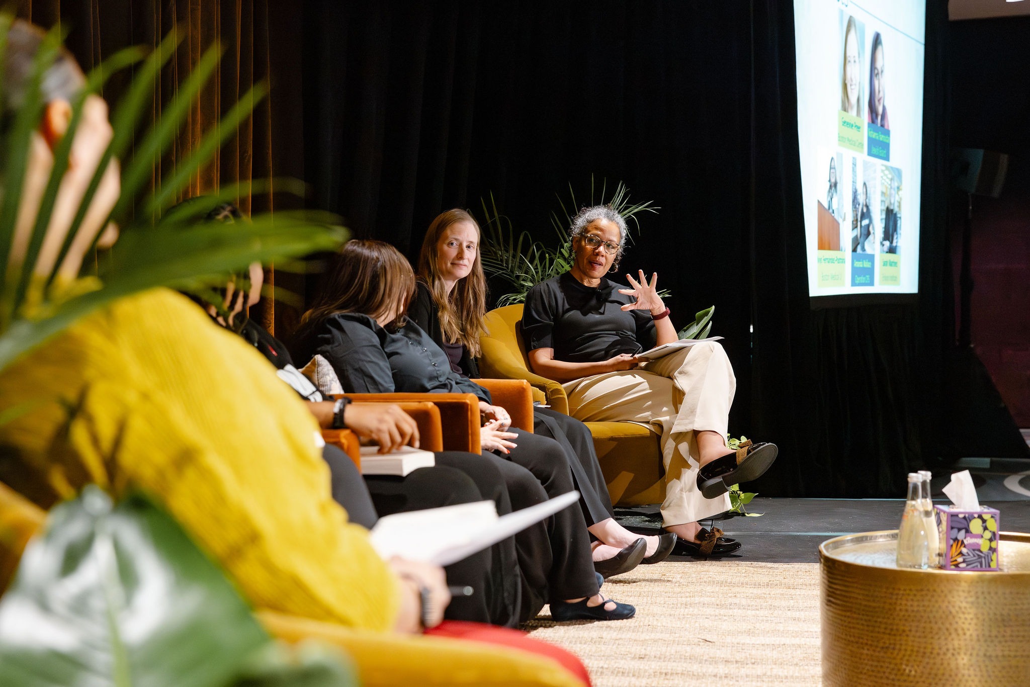 Panelists seated in mustard velvet armchairs on stage at the Planning & Development Network Conference at Sofitel Chicago Magnificent Mile