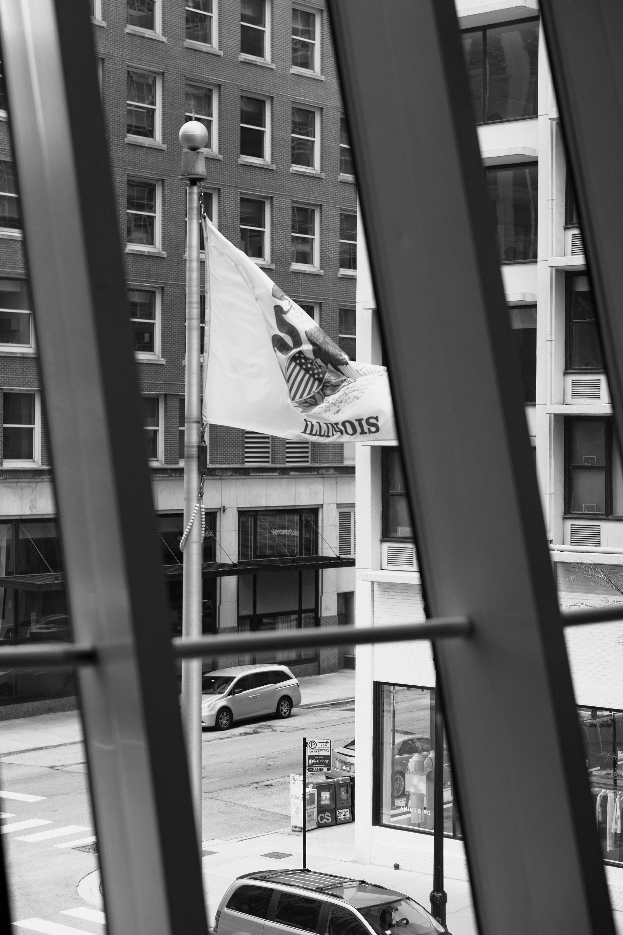 Black-and-white view of the Illinois state flag through the venue windows