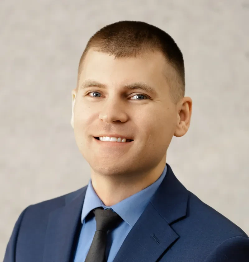 Alex Radig, CPA, founder of Blueprint Tax, in a navy suit and blue shirt
