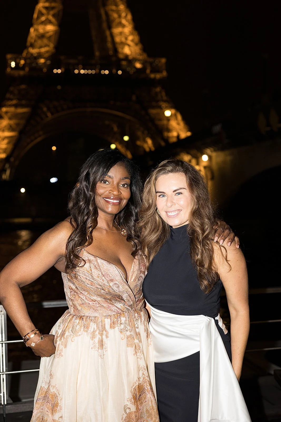 Brianne Garritano with a client before the illuminated Eiffel Tower in Paris
