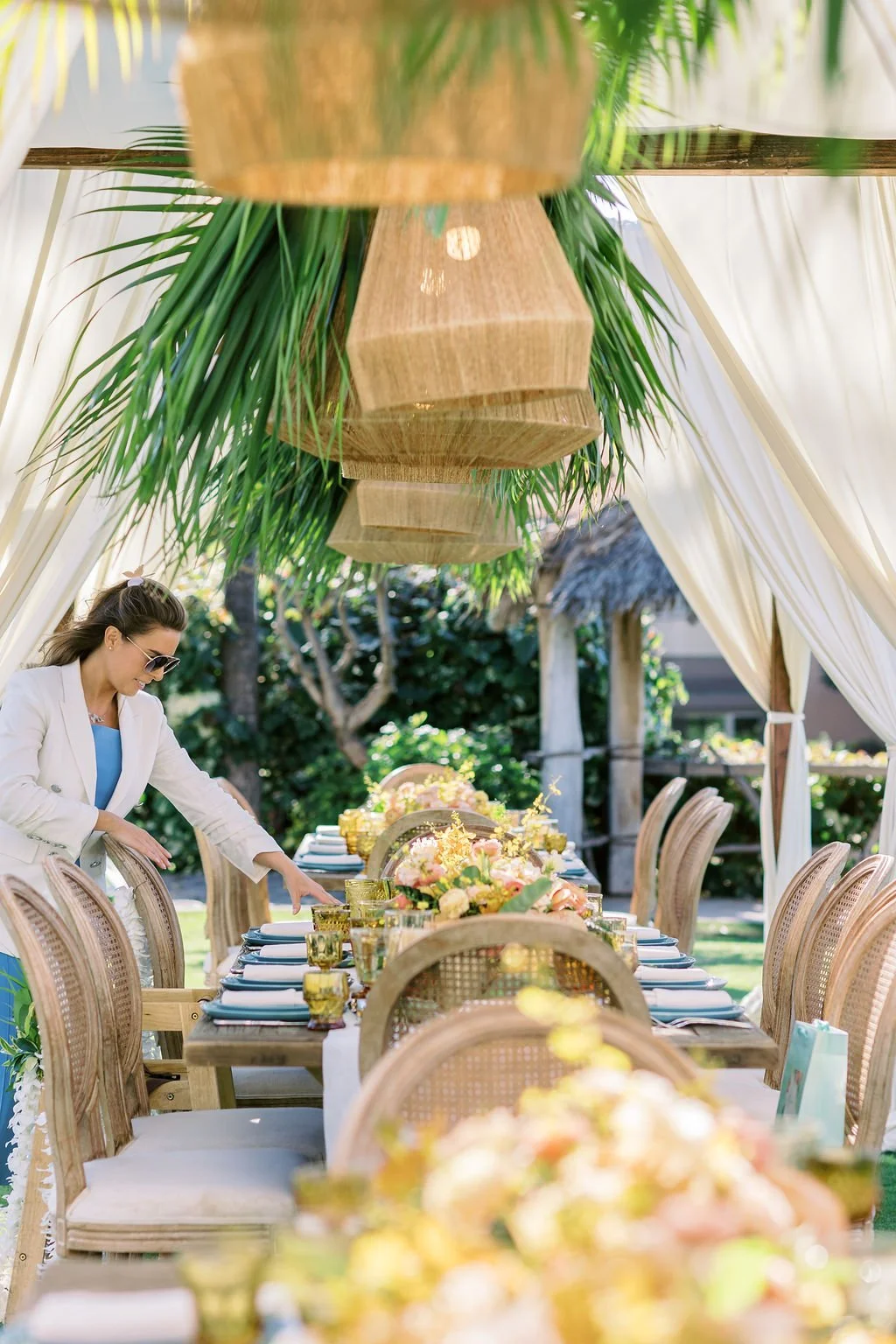Brianne Garritano setting a tropical outdoor reception table