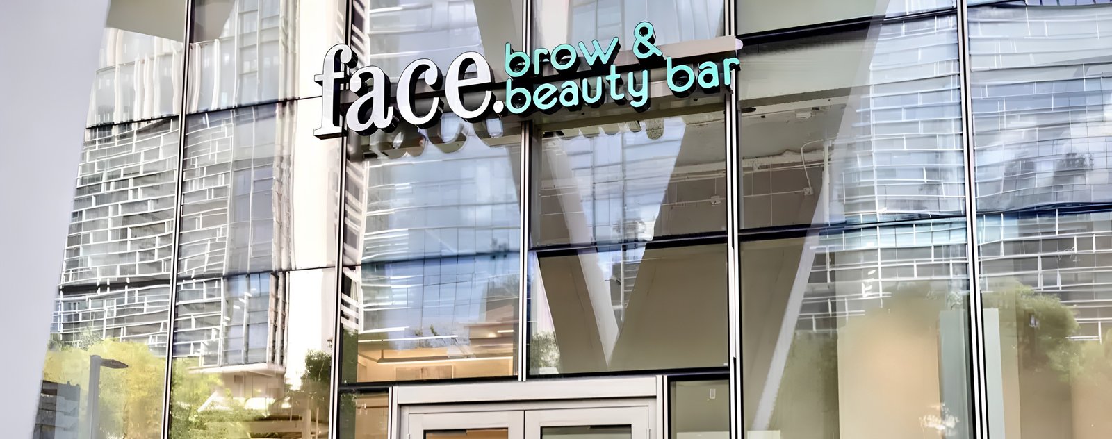 An esthetician shaping a client's eyebrows at the beauty bar