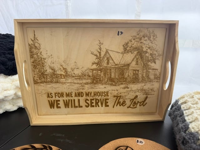 A wooden serving tray engraved with a farmhouse and the words as for me and my house we will serve the Lord