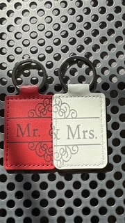 Red and white leather keychains engraved Mr. and Mrs.